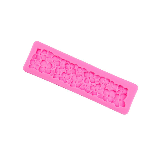 A vibrant pink silicone mould shaped like hydrangea flowers. The mould features intricate designs of multiple flowers and leaves in a rectangular form.