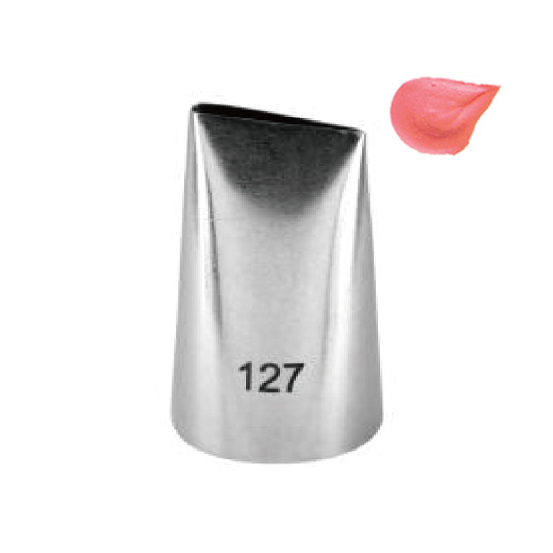 A metal piping nozzle labeled &quot;127&quot; with a tapered design, positioned next to a small dollop of pink icing. The nozzle has a slightly open tip to allow for decorating with frosting.