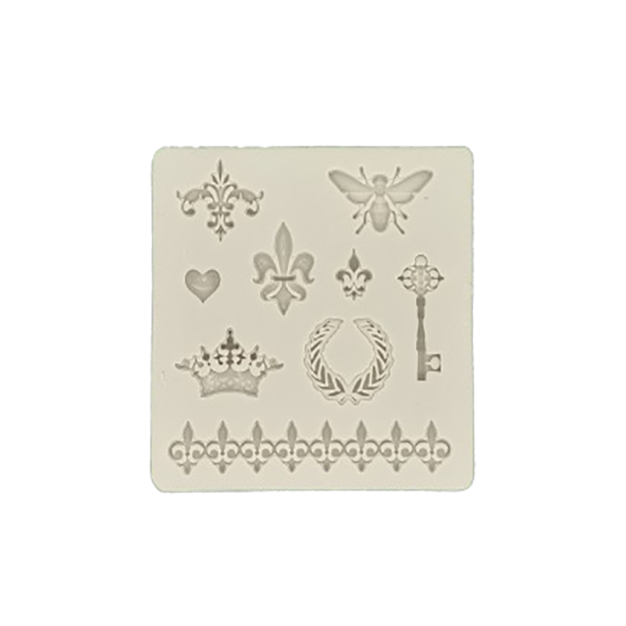 An off-white silicone mold featuring various decorative designs. The mold includes a butterfly, a key, a heart, a crown, a laurel wreath, a fleur-de-lis, and ornate patterns. The designs are arranged in a grid format, allowing for the creation of detailed decorations, suitable for baking or crafting.