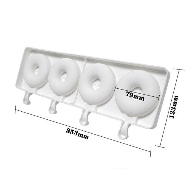 A white silicone mold designed to make four donut-shaped cakesickles. The mold features four circular cavities, each with a central hole, and is in a rectangular shape. Measurements are provided, showing the total length as 353mm and the height as 133mm, with each donut cavity measuring 79mm in diameter. The mold has a flat base and small handles for easy lifting.