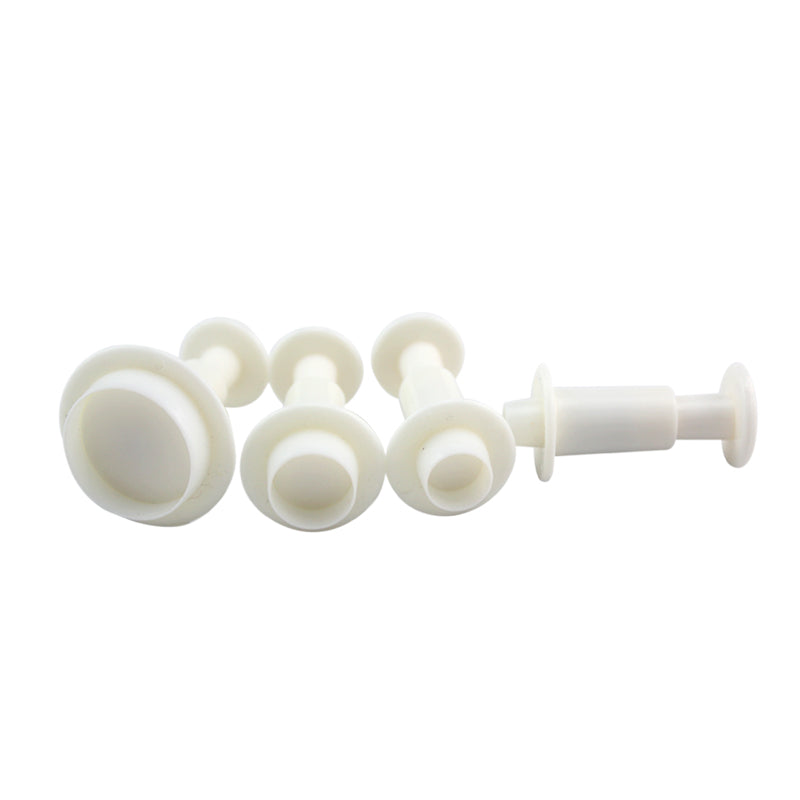 A set of four round plunger cutters, varying in size, made of white plastic. Each cutter features a circular cutting edge and a cylindrical handle for easy grip. They are arranged from largest to smallest, illustrating their different diameters.