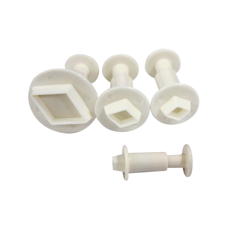 A set of four plunger cutters in various geometric shapes, including a diamond, square, and hexagon. The cutters are made of white plastic with circular handles. The shapes are displayed upright, with the diamond-shaped cutter positioned in the center.