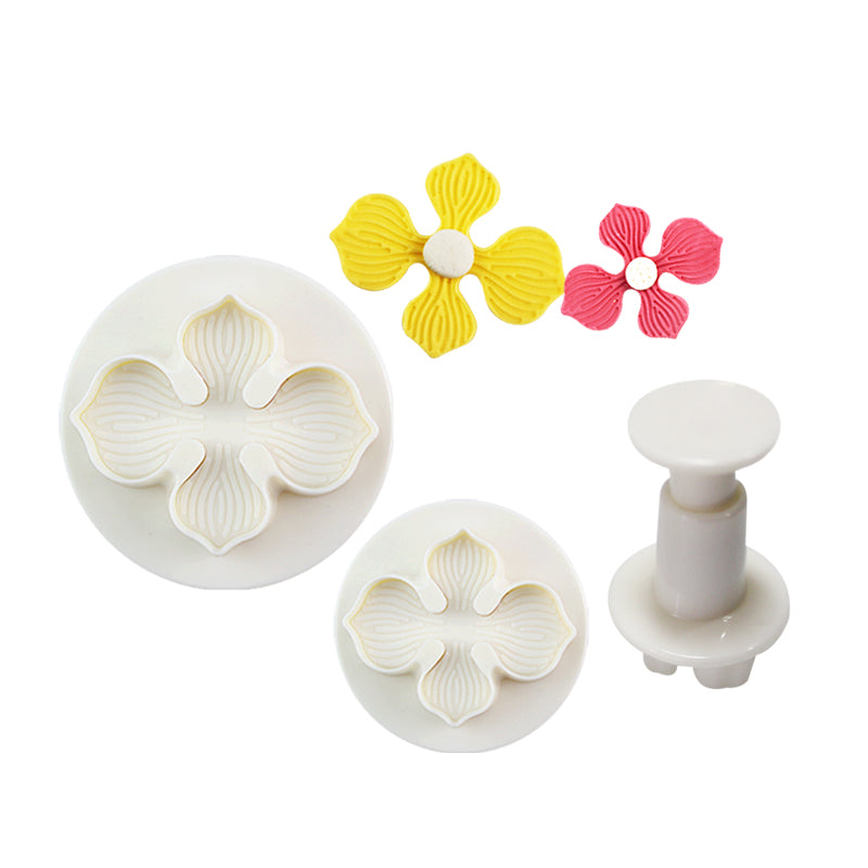 The image features a set of three plunger cutters designed in the shape of laurustinus flowers. There are two white, round cutters with a floral design on the surface, varying in size, and a plunger tool that fits into one of the cutters. Additionally, there are two colorful flower shapes made from modeling material: one yellow and one pink. The yellow flower has four petals and a round center, while the pink one is smaller and has a similar design.