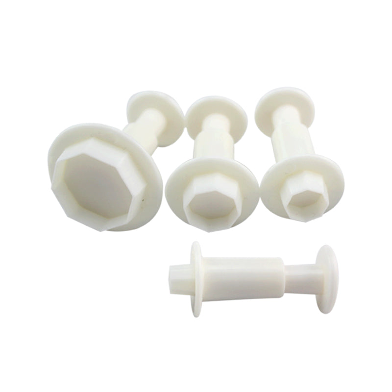 A set of four white plunger cutters in an octagon shape, featuring varying sizes. Each cutter has a wide base with a handle and is designed to create octagonal shapes in dough or other materials. The cutters are arranged in a way that displays their different dimensions, with one cutter positioned horizontally and the others standing upright. The overall appearance is clean and simple, emphasizing the functional design of the product.