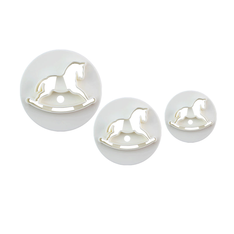 A set of three white plunger cutters in the shape of rocking horses, displayed in varying sizes. Each cutter features a rounded shape with a rocking horse silhouette cut out in the center.