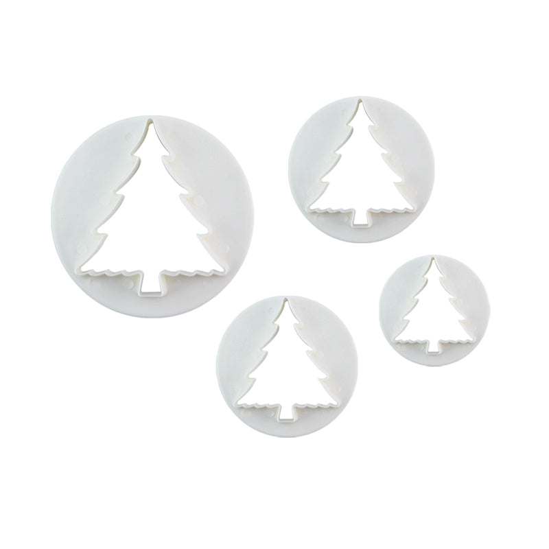 A set of four plunger cutters shaped like Christmas trees, each with a round outer edge. The cutters are arranged in varying sizes, with the largest being at the back and the smallest at the front. The cutters are white with a smooth finish and feature a tree design cut out in the center.