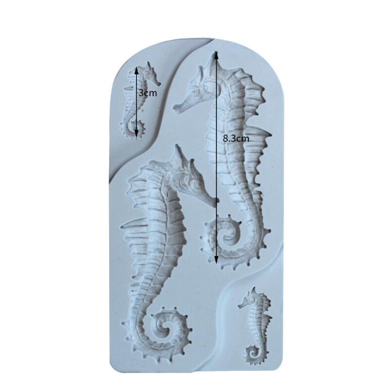 A white silicone mould shaped like seahorses. The mould features three seahorse designs: one small seahorse measuring 3 cm, and two larger seahorses, with the larger one measuring 8.3 cm. The mould has a smooth, curved outline and detailed texture on the seahorse shapes.