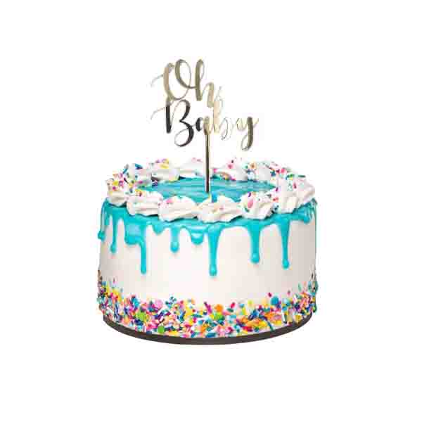 A round cake with a white base features blue frosting drizzled down the sides. The top is adorned with a ring of white whipped cream and colorful sprinkles. At the center of the cake, a gold acrylic topper reads &quot;Oh Baby,&quot; standing upright on a stick. The cake is displayed on a round cake board, and the overall appearance is festive and celebratory.