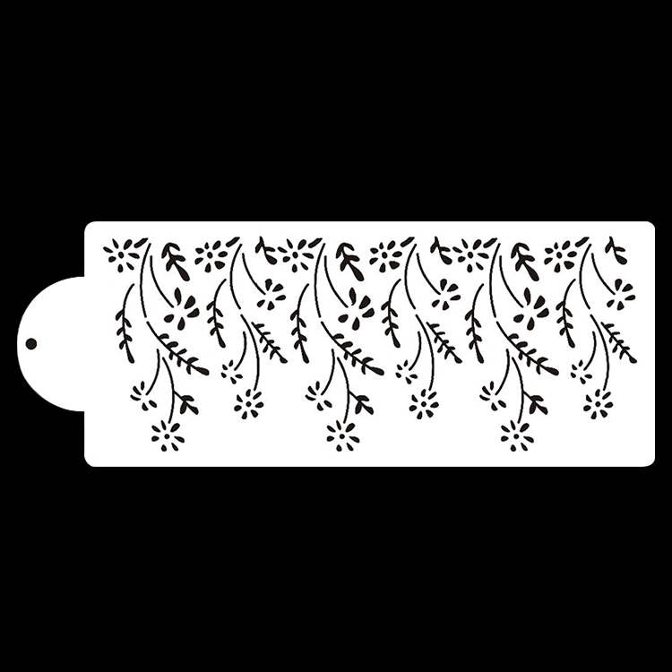 A white cake stencil featuring a design of cascading floral patterns. The stencil includes various small flowers and leafy vines, with a rounded tab on one side for easy handling. The background is black, highlighting the intricate floral design on the stencil.