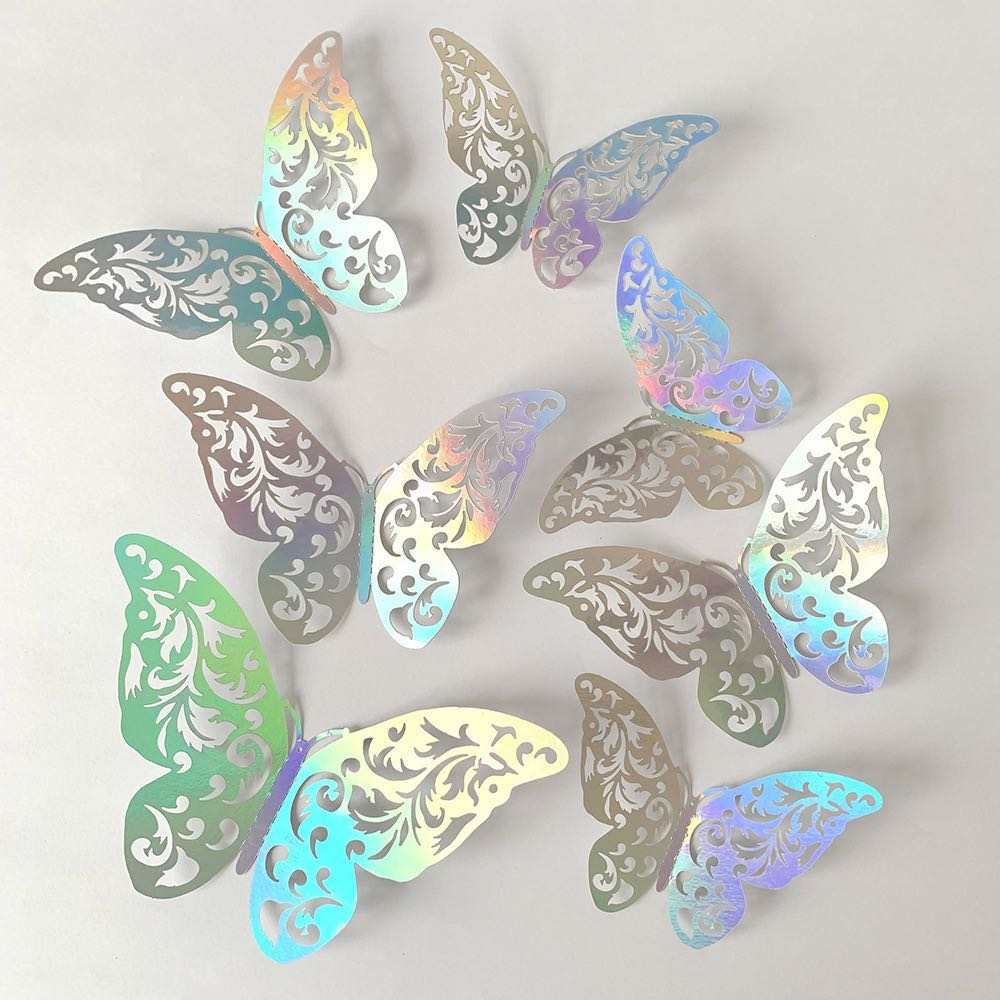 A collection of 12 decorative silver butterfly stickers, featuring intricate cut-out designs. The butterflies display a shiny, iridescent finish with a mix of silver, green, and pastel hues, arranged on a light gray background.