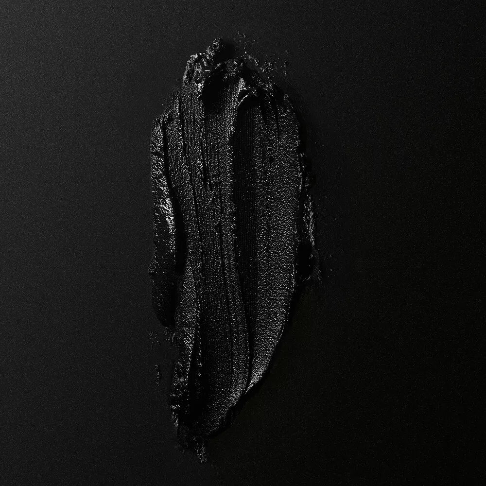 Close-up of vanilla paste swatch on a dark background