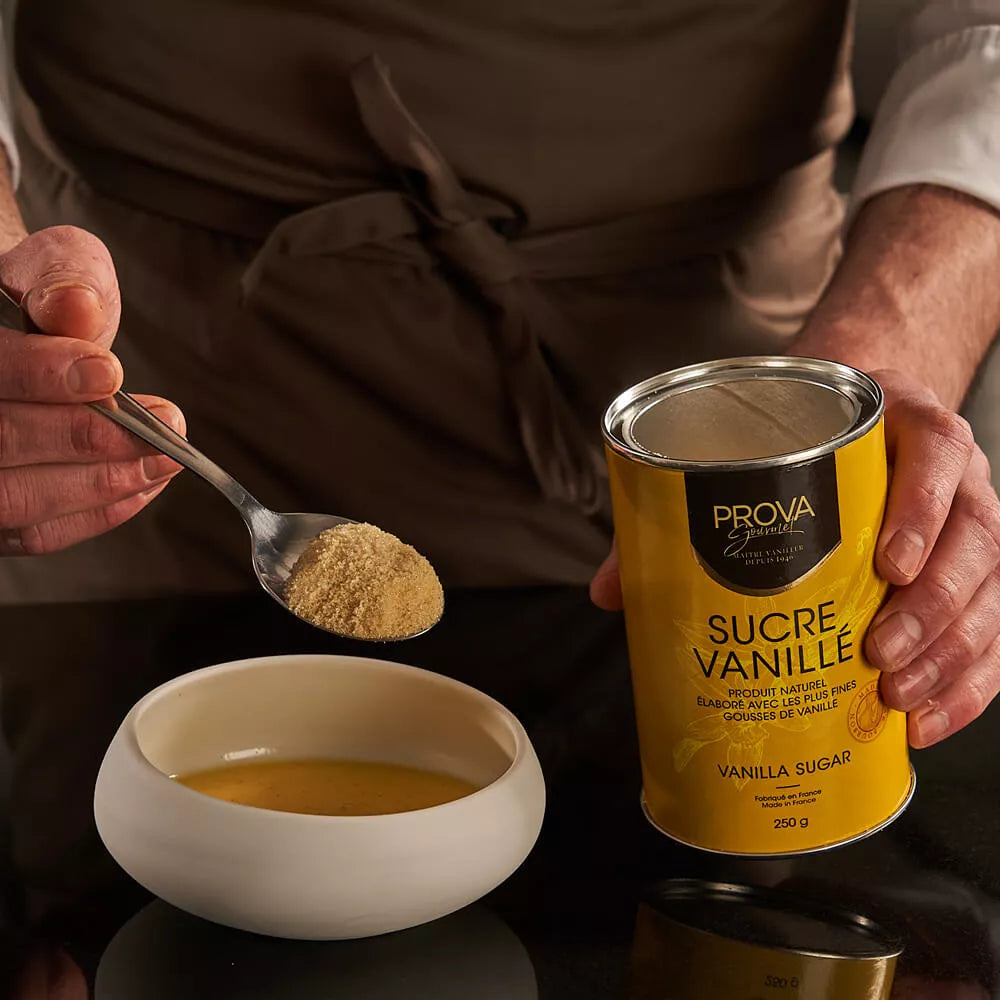 Person holding a can of Prova Vanilla Sugar and scooping it into a bowl.