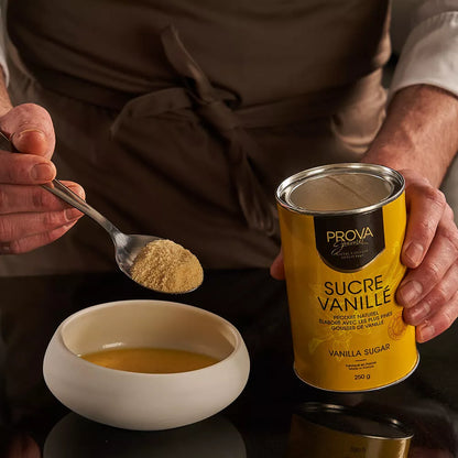 Person holding a can of Prova Vanilla Sugar and scooping it into a bowl.