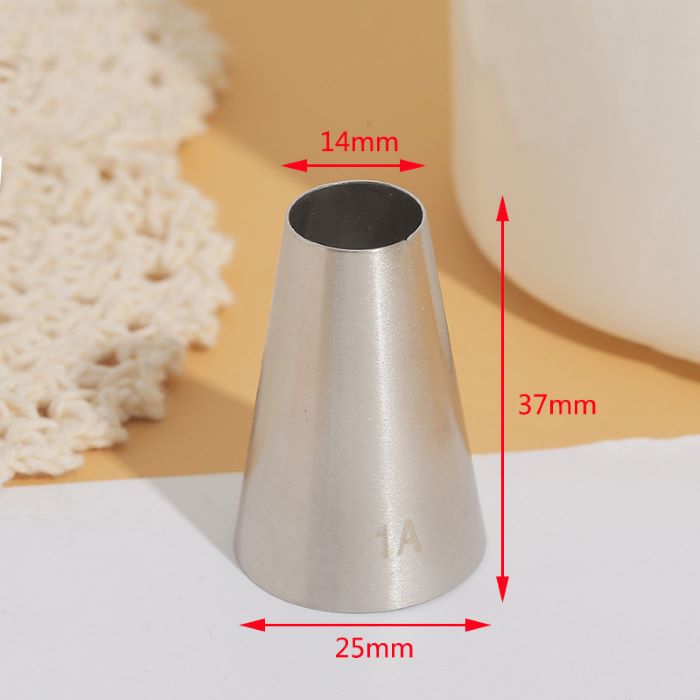 A stainless steel piping nozzle labeled "1A" is displayed on a smooth surface. The nozzle has a conical shape with a narrower opening at the top measuring 14mm in diameter, a wider base measuring 25mm, and a height of 37mm. The background features a textured, crocheted fabric and a blurred white object.