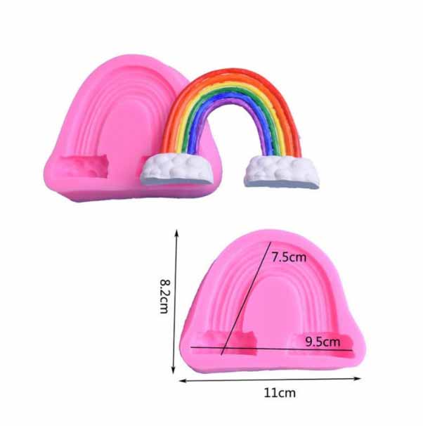 A pink silicone mold shaped like a rainbow, featuring a colorful rainbow with red, orange, yellow, green, blue, and purple arcs, topped with white clouds. The dimensions of the mold are marked: 8.2 cm tall, 9.5 cm wide, and 11 cm long. The design includes two small cavities at the base for additional shapes.