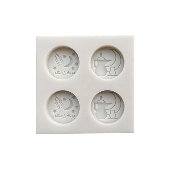 A square white silicone mould featuring four circular compartments. Each compartment contains imprints of festive designs including a crescent moon, a star, a lantern, and a traditional pot, alongside Arabic text. The mould is intended for creating decorative items for Eid celebrations.