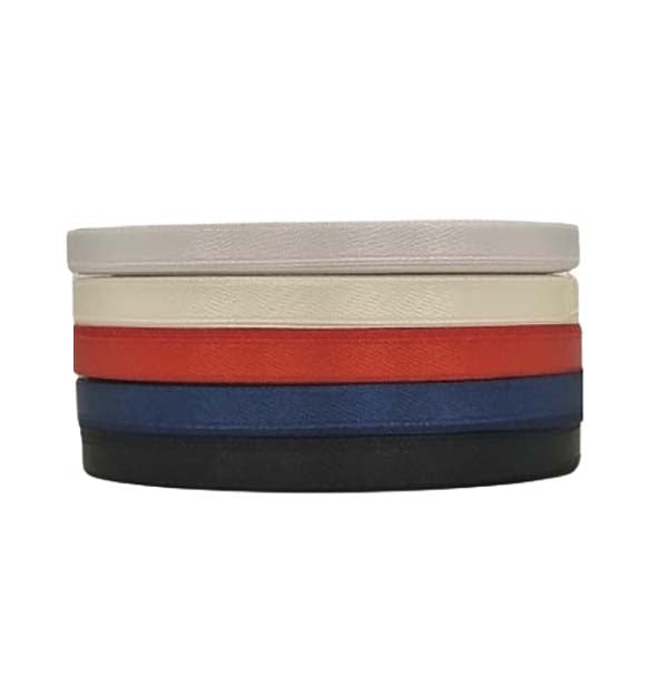 A stack of satin ribbon rolls in various colors, including cream, ivory, red, blue, and black. Each roll is 5mm wide and collectively showcases a range of vibrant colors suitable for crafting and decoration purposes.