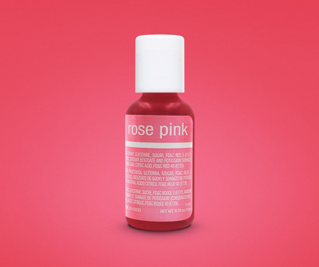 A small bottle of Chefmaster Liqua-Gel color in rose pink, 0.7 oz (20 ml). The bottle has a white cap and features a label with the words &quot;rose pink&quot; in pink text. The background is a solid pink color, and the bottle contains food color ingredients.