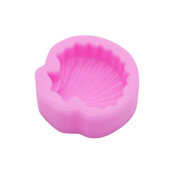 A pink silicone mould shaped like a seashell, featuring a textured interior that mimics the details of a shell. The outer edge is smooth, and the mould is designed to hold various materials for crafting, baking, or food preparation.