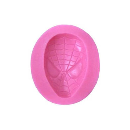 A pink silicone mold shaped like a Spider-Man face, featuring detailed web patterns and facial features. The mold is oval in shape and has a raised design of Spider-Man&