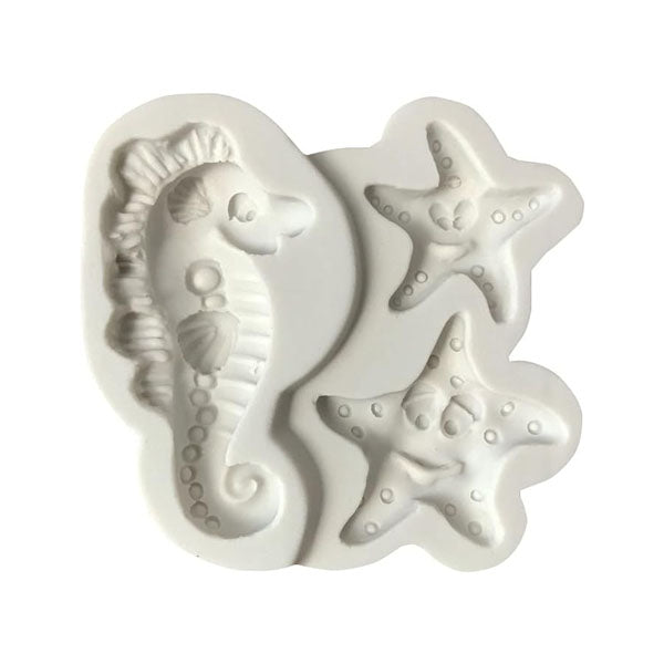 A white silicone mold featuring three designs: a seahorse on the left and two smiling starfish on the right. The seahorse has detailed features including a shell and scales, while the starfish have playful expressions. The overall shape of the mold is smooth and gently curved.
