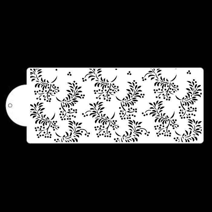 The image features a cake stencil with a repeating floral pattern. The design includes intricate swirls and leaves, accompanied by small circular accents, all rendered in black against a white background. The stencil has a rectangular shape with a rounded corner on one side, making it easy to handle. This decorative pattern is suitable for applying to cakes and other baked goods.