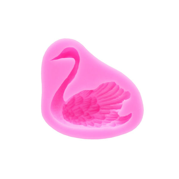 A pink silicone mold shaped like a swan, featuring detailed engravings of the swan?s neck and wings. The mold has a smooth surface and a rounded, organic shape.