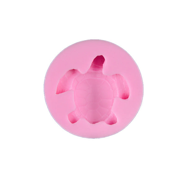 A circular pink silicone mould featuring the shape of a turtle, with detailed impressions of the turtle&