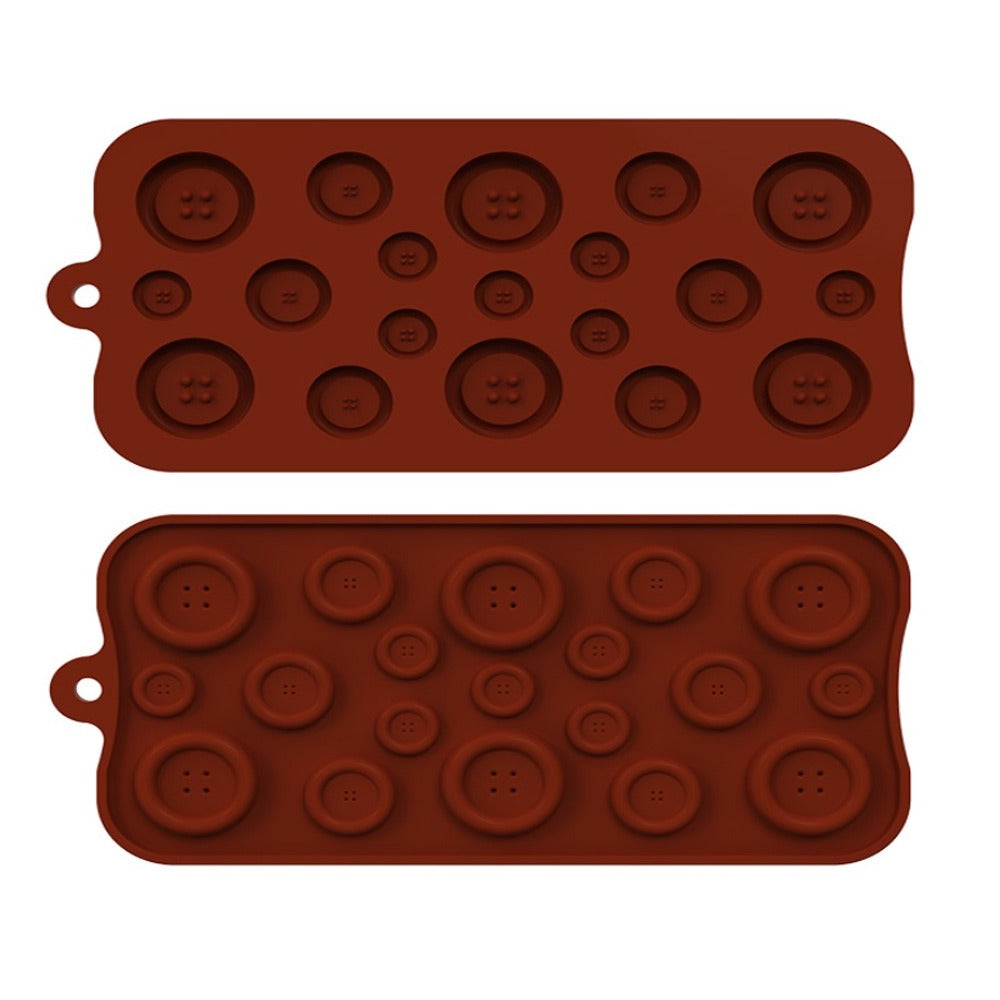 Two silicone button mould trays stacked on top of each other. Each tray has various sizes of button-shaped cavities in a reddish-brown color, with impressions of button holes on each cavity. The moulds have a smooth surface and rounded edges, with a small handle on the side for easy handling.