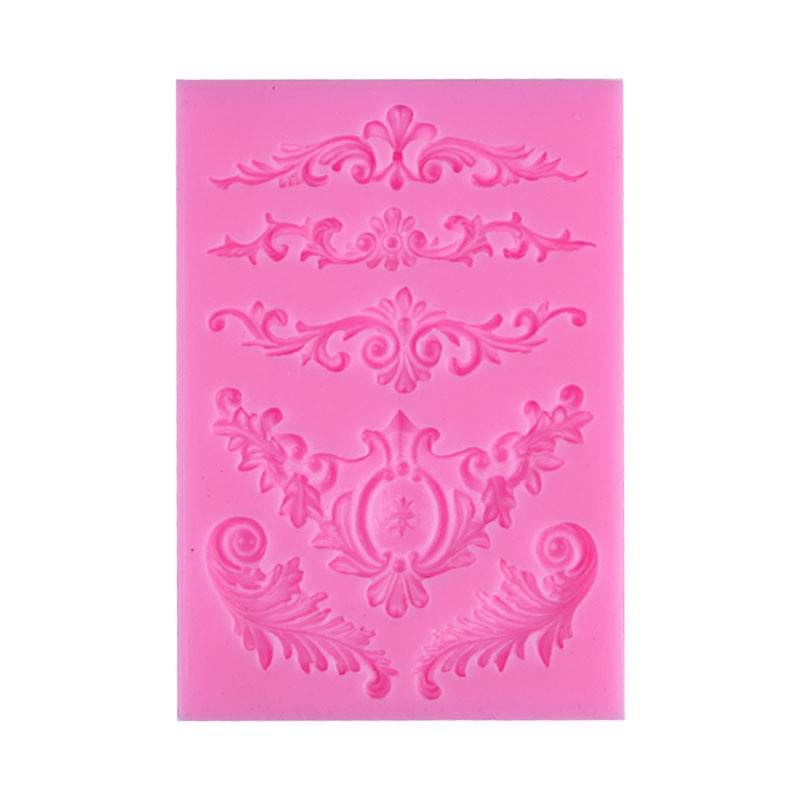 A pink decorative silicone mould featuring intricate patterns. The mould contains multiple designs, including floral and scrollwork motifs, arranged in horizontal bands. Each design varies in shape and detail, showcasing elegant curves and embellishments suitable for crafting or baking projects.