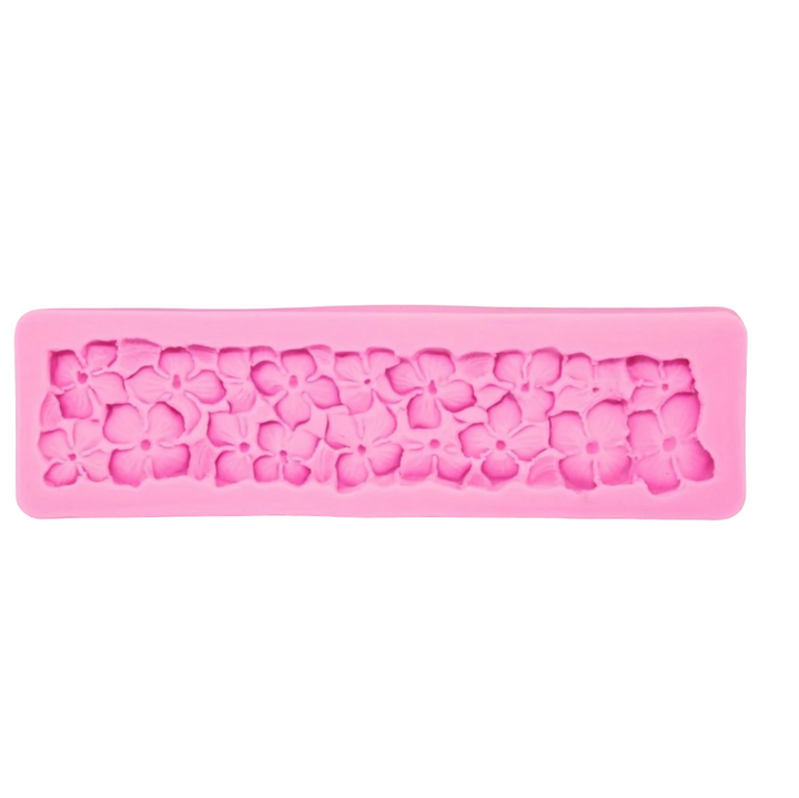 A pink silicone mould designed to create hydrangea flower shapes. The mould features a row of intricately detailed flowers, with a smooth rectangular border. Each flower is outlined with textured detailing, suitable for baking or crafting use.