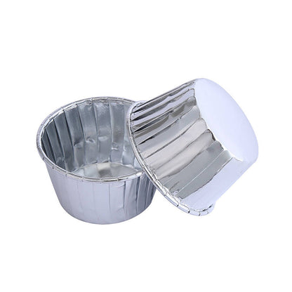 Two silver aluminum foil ramekins are shown. One is upright, revealing its interior, while the other is placed upside down beside it. The ramekins have a smooth finish with vertical ridges on the sides.