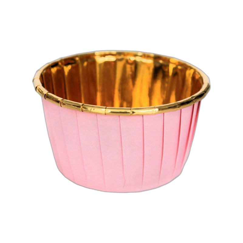 A pink cupcake liner with pleated sides and a shiny gold interior, set against a black background, creating an elegant and festive appearance.