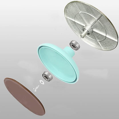 An exploded view of an aluminum revolving turntable consisting of three main components: a metallic top plate with a textured surface, a central turquoise rotating section, and a brown bottom plate. Several small hardware pieces, including bearings and a screw, are visible, illustrating the assembly of the turntable. The background is a smooth gradient from light to dark gray.