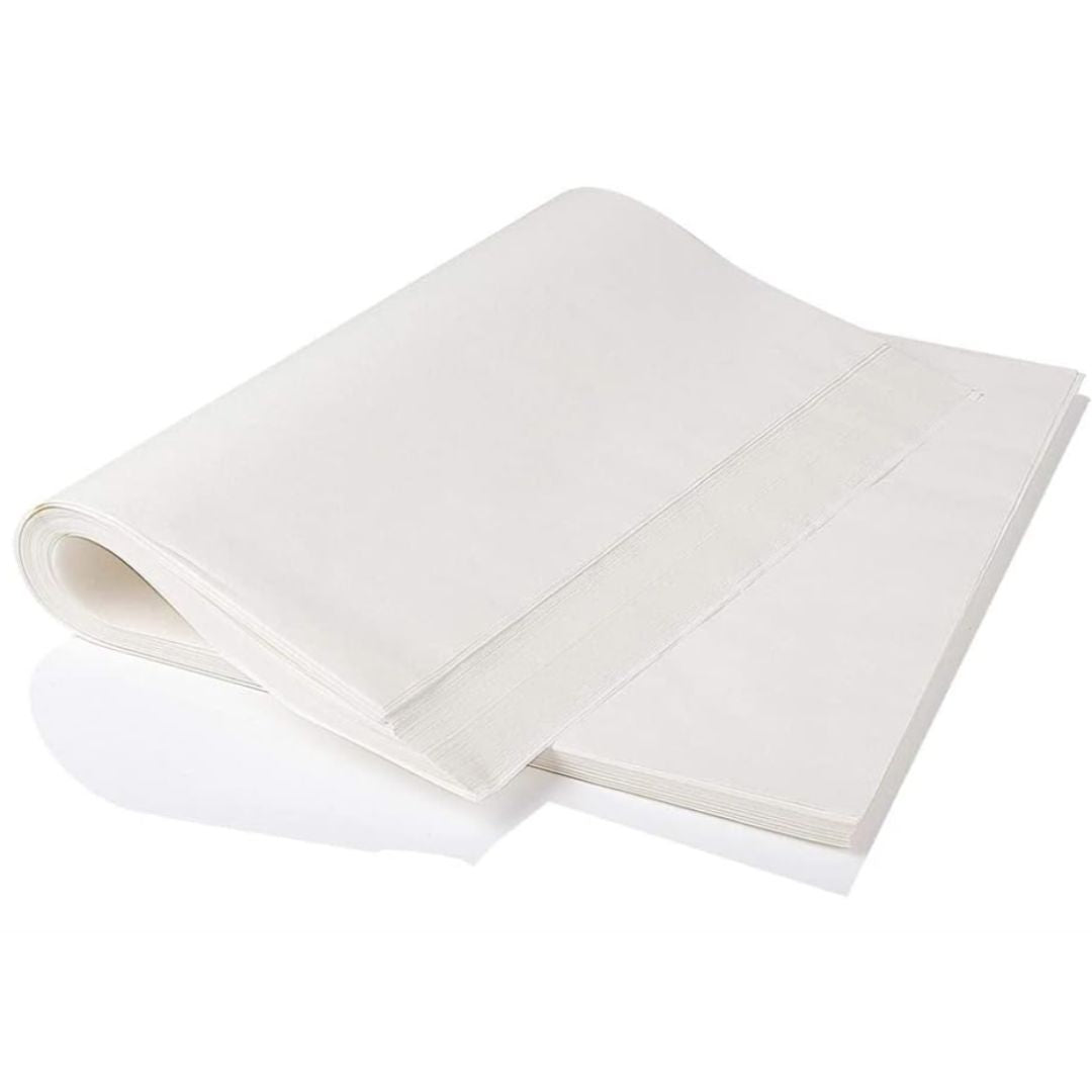 A stack of smooth, white sheets of paper, partially folded over, lies on a flat surface. The paper’s texture looks clean and unmarked, evoking simplicity.
