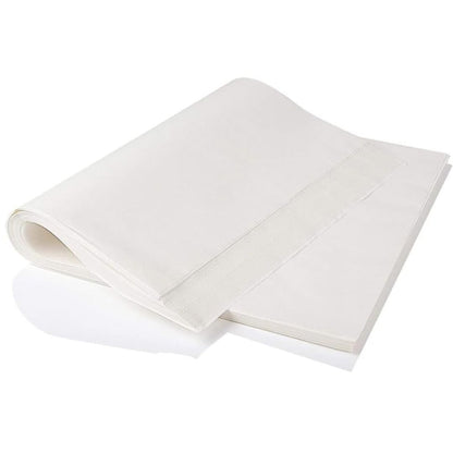 A stack of smooth, white sheets of paper, partially folded over, lies on a flat surface. The paper’s texture looks clean and unmarked, evoking simplicity.