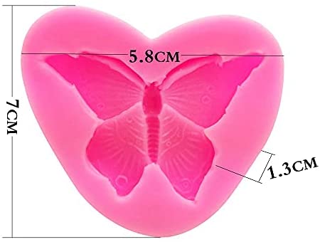A pink silicone mold in the shape of a heart, featuring a design of two butterflies. The dimensions are labeled: 5.8 cm wide, 7 cm tall, and 1.3 cm deep.