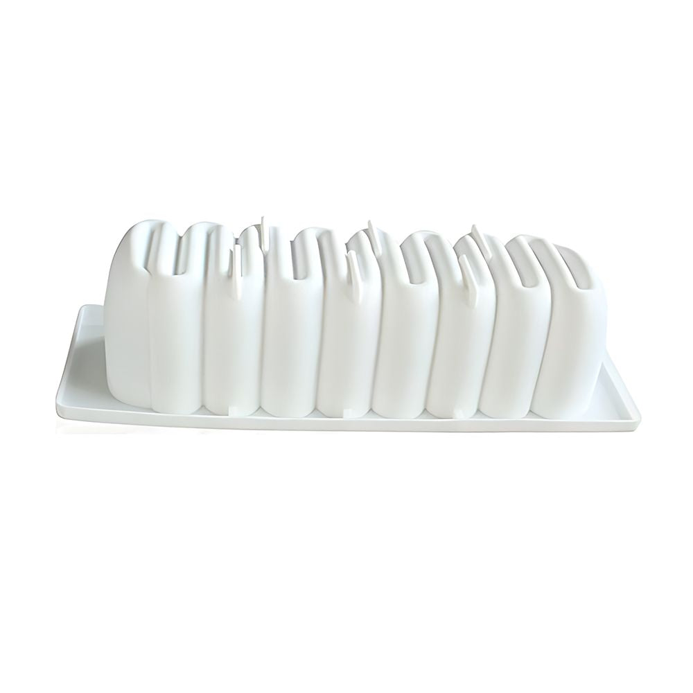 White sculptural vase set shaped like an abstract skyline on a rectangular tray, conveying a modern and minimalist design aesthetic.