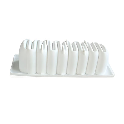 White sculptural vase set shaped like an abstract skyline on a rectangular tray, conveying a modern and minimalist design aesthetic.