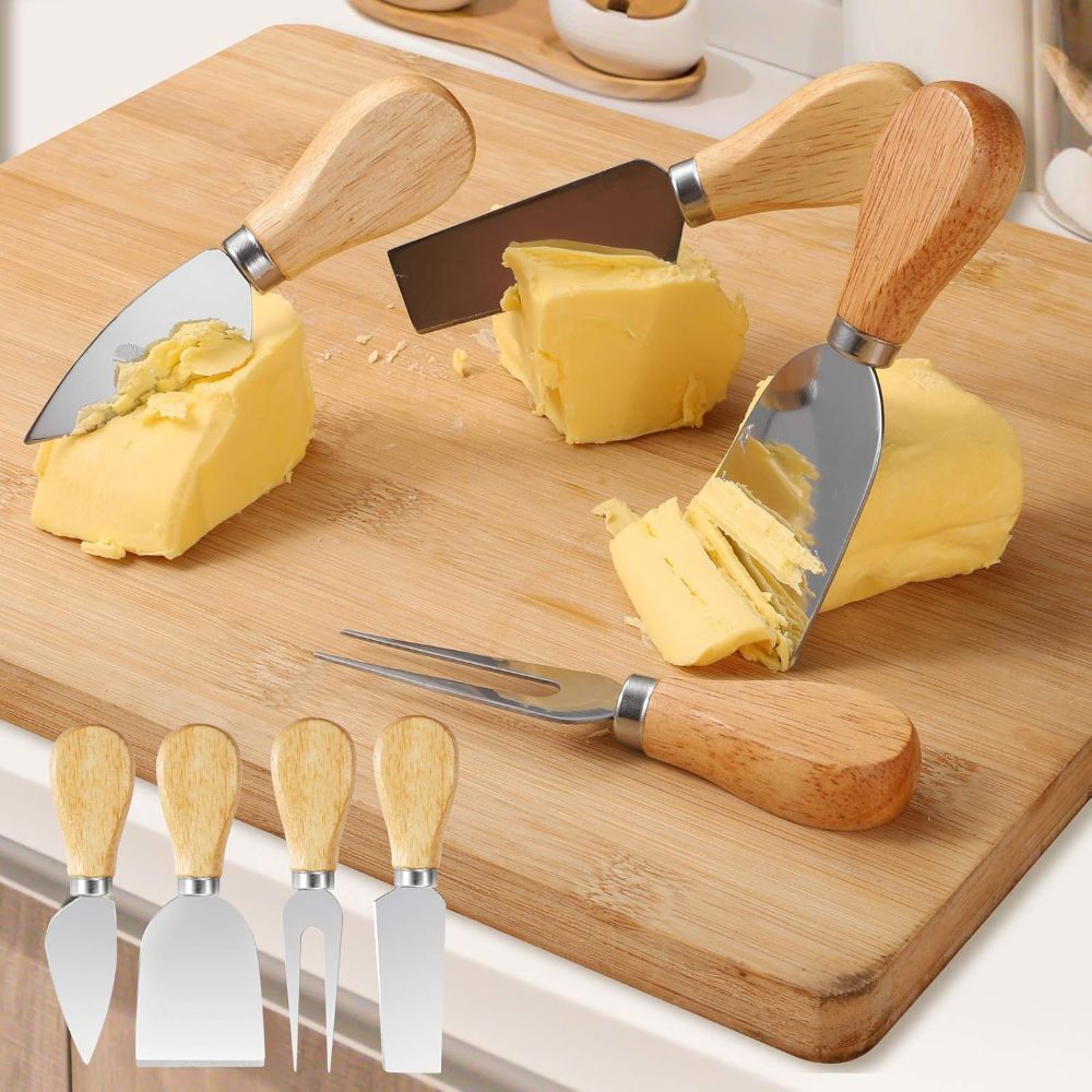 cheese knives with wooden handles on a wooden cutting board with cheese.
