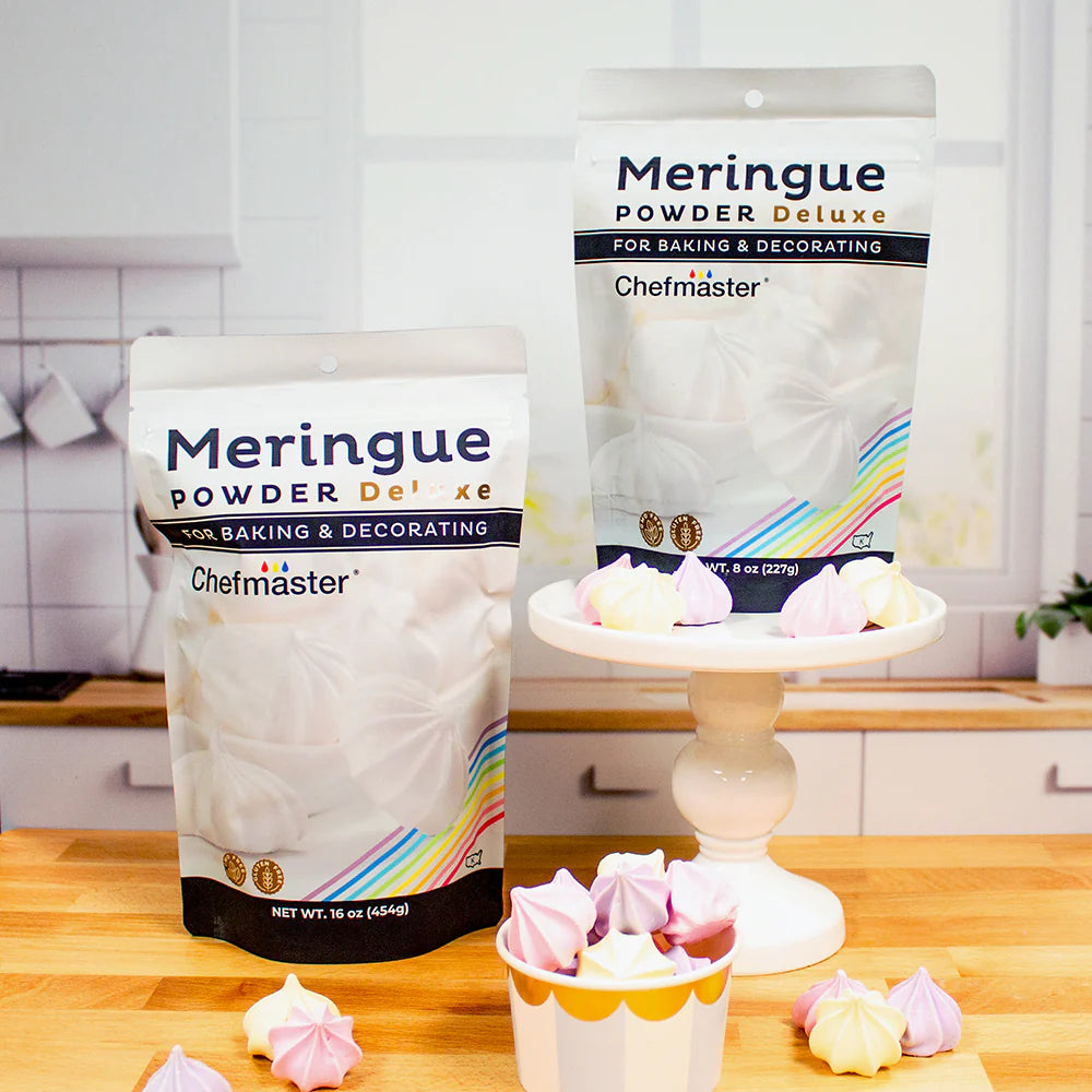 A box of meringue next to a frosted cake displayed on a countertop.
