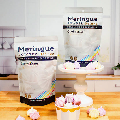 A box of meringue next to a frosted cake displayed on a countertop.