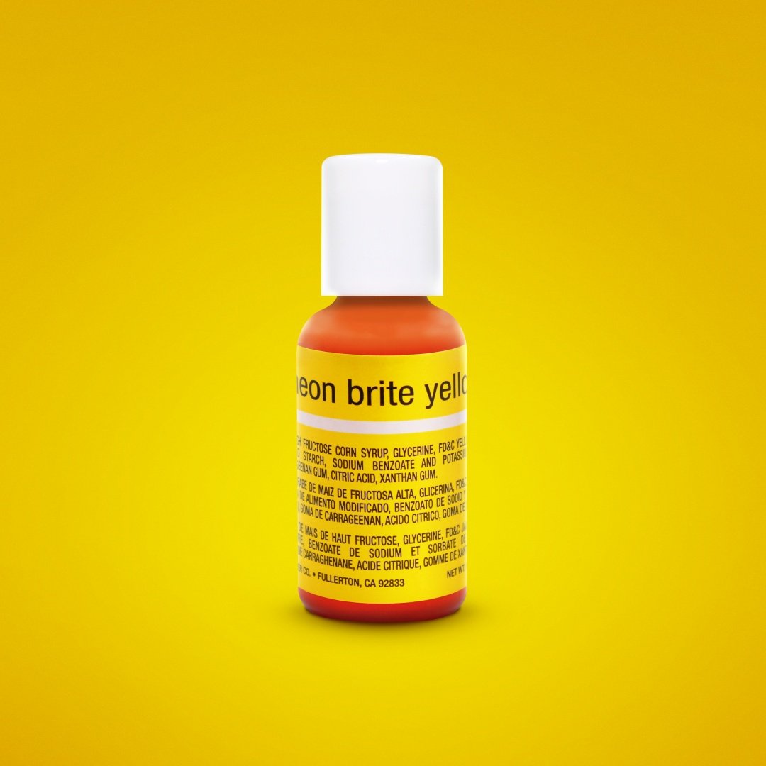 The image features a small bottle of liquid food color, specifically "Chefmaster Liqua Gel Color Neon Brite Yellow." The bottle has a white cap and a bright orange base. The label prominently displays the product name in yellow text. The background is a vivid yellow, complementing the neon theme of the product. The label includes ingredients and information in both English and Spanish. The bottle is positioned upright, focused to emphasize its contents.