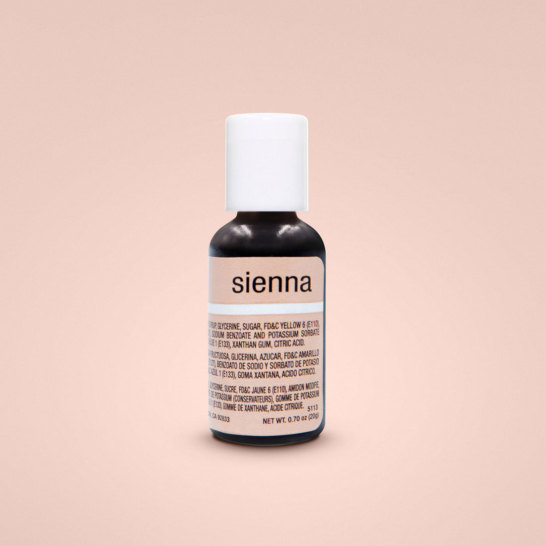 A small black bottle of Chefmaster Liqua Gel Color labeled "sienna." The bottle has a white cap and contains 0.7 oz (20 ml) of the product. The label includes ingredients and nutritional information, with some text in English and Spanish. The background is a soft, neutral peach color.