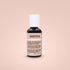 A small black bottle of Chefmaster Liqua Gel Color labeled "sienna." The bottle has a white cap and contains 0.7 oz (20 ml) of the product. The label includes ingredients and nutritional information, with some text in English and Spanish. The background is a soft, neutral peach color.