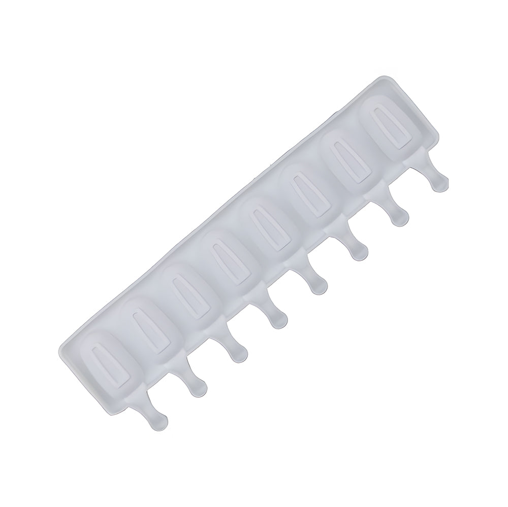 A white silicone ice mold with seven cavities shaped like popsicles, each with a stick extension. The mold is angled diagonally on a plain background.