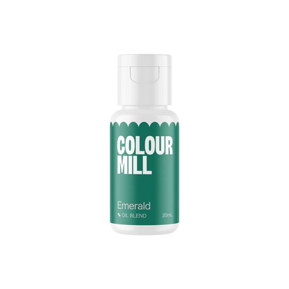A small white bottle with a green label displaying the text "Colour Mill" in bold white letters. It reads "Emerald" below, indicating an oil blend.