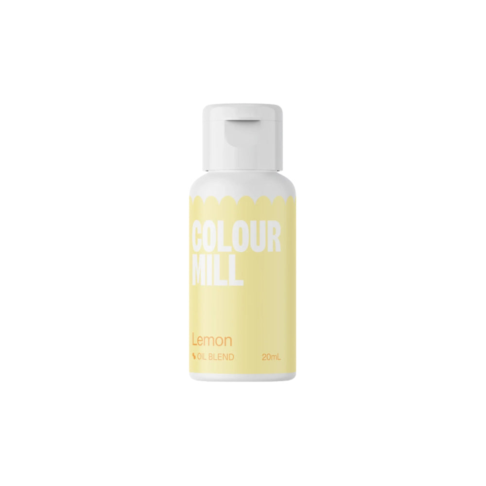 A bottle of Colour Mill oil-based food color in lemon flavor, 20ml. The bottle has a light lemon-yellow label with bold white text that reads "COLOUR MILL" and "Lemon" in a smaller font. The label also indicates it is an "OIL BLEND" and displays the volume as "20mL." The bottle has a white cap. The background is plain and dark, highlighting the product.