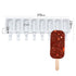 The image features a white silicone mould designed for making diamond-shaped cakesickles. The mould has eight cavities, each with a geometric pattern, and dimensions of 378mm in length, 130mm in height, and 23mm in depth. Beside the mould is a finished cakesickle, which resembles a rectangular ice cream treat with a wooden stick, coated in chocolate and sprinkled with small red pieces, likely bits of fruit or candy.