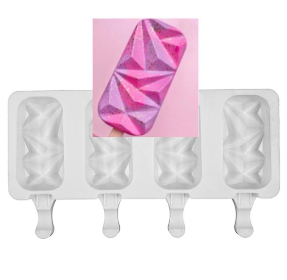 The image features a four-cavity silicone mold designed for making cakesickles. The mold is white and has four cavities shaped like diamond gems, allowing for the creation of decorative frozen treats. There is an inset image of a completed cakesickle, which is colorful with a pink and purple geometric design that reflects light, resembling a gem or crystal. The cakesickle is on a stick and is set against a soft pink background.